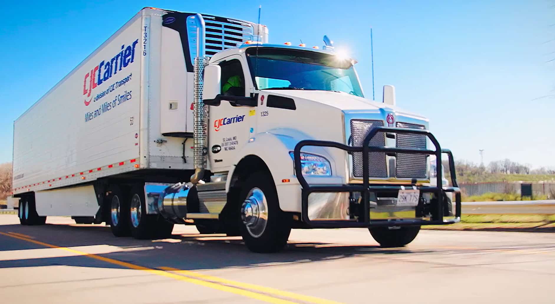 Front view of a semi truck on the passenger side of the cab