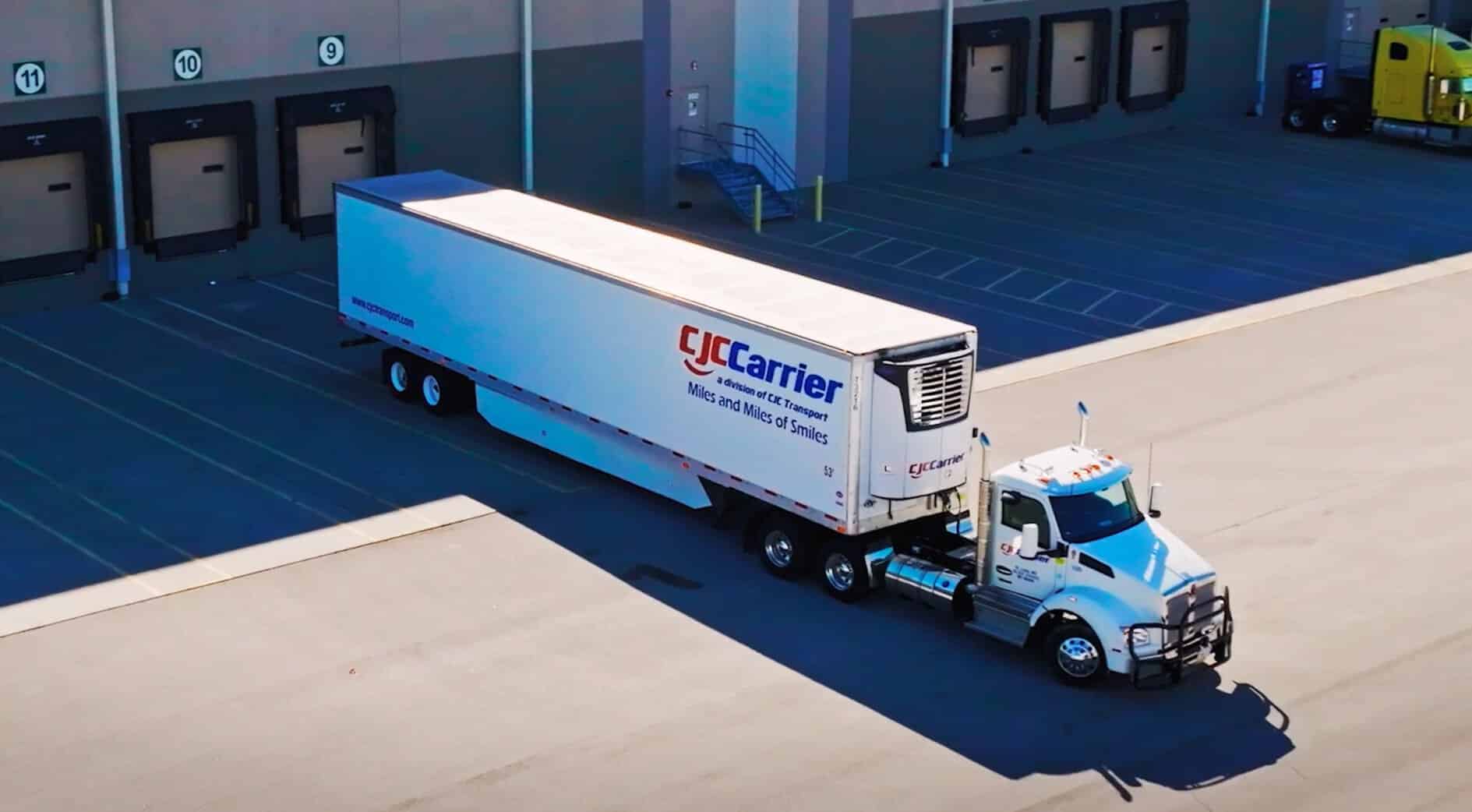 Semi truck backing straight into a loading dock