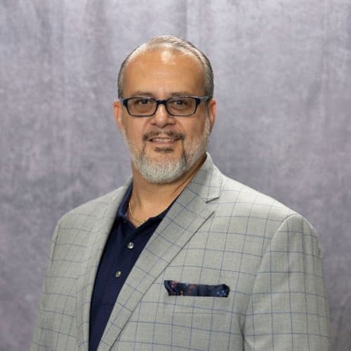 CJC Transport - Vinny Kozak, man in a navy blue polo shirt and blazer