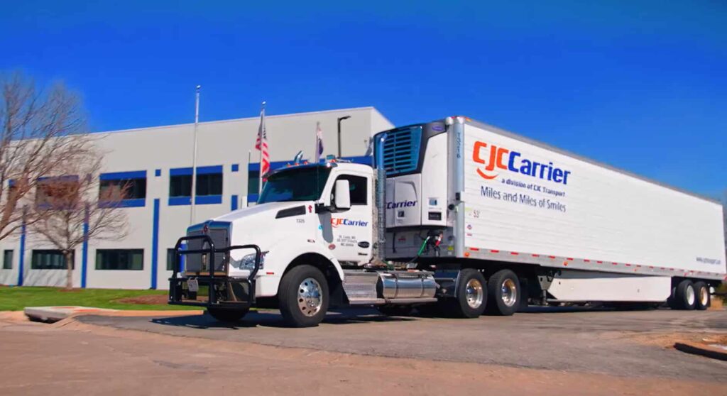 Semi-tractor-trailer with building in the background